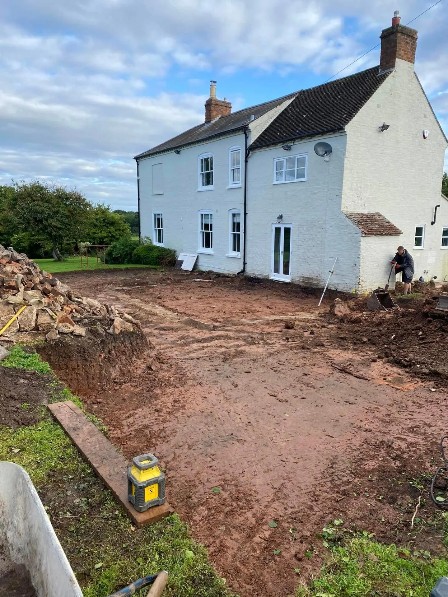 Farmhouse extension site levelled to formation with rotary laser set up on timber board by JRC Developers