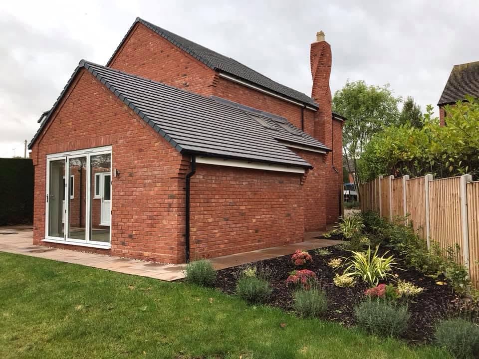 Side view of the completed Inkberrow house from the garden