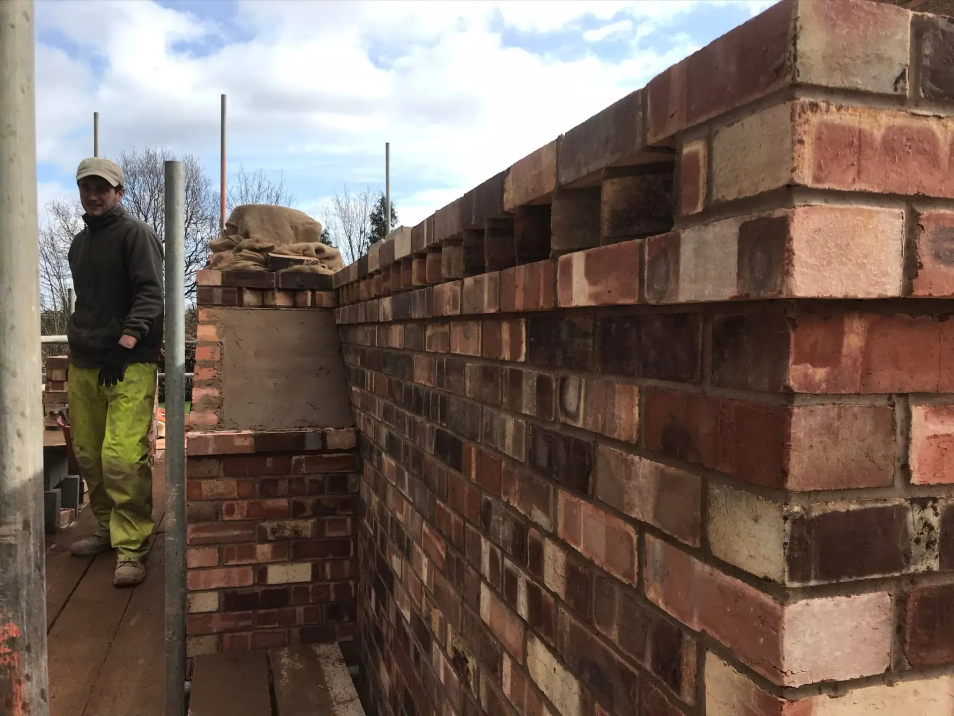 Close-up of detailed red brickwork with dentil courses and feature brick detailing during construction at Wootton Mead