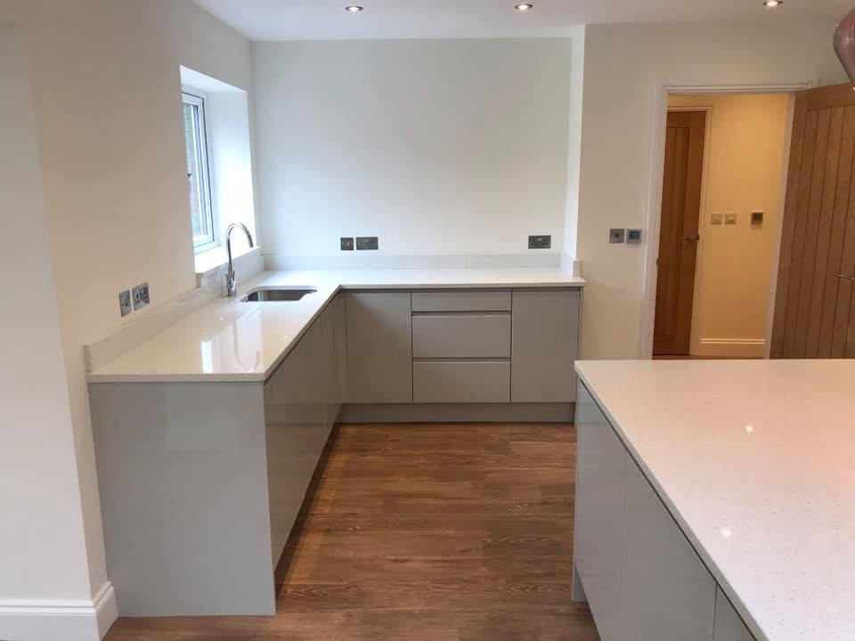 L-shaped white stone worktops in the Inkberrow new-build kitchen