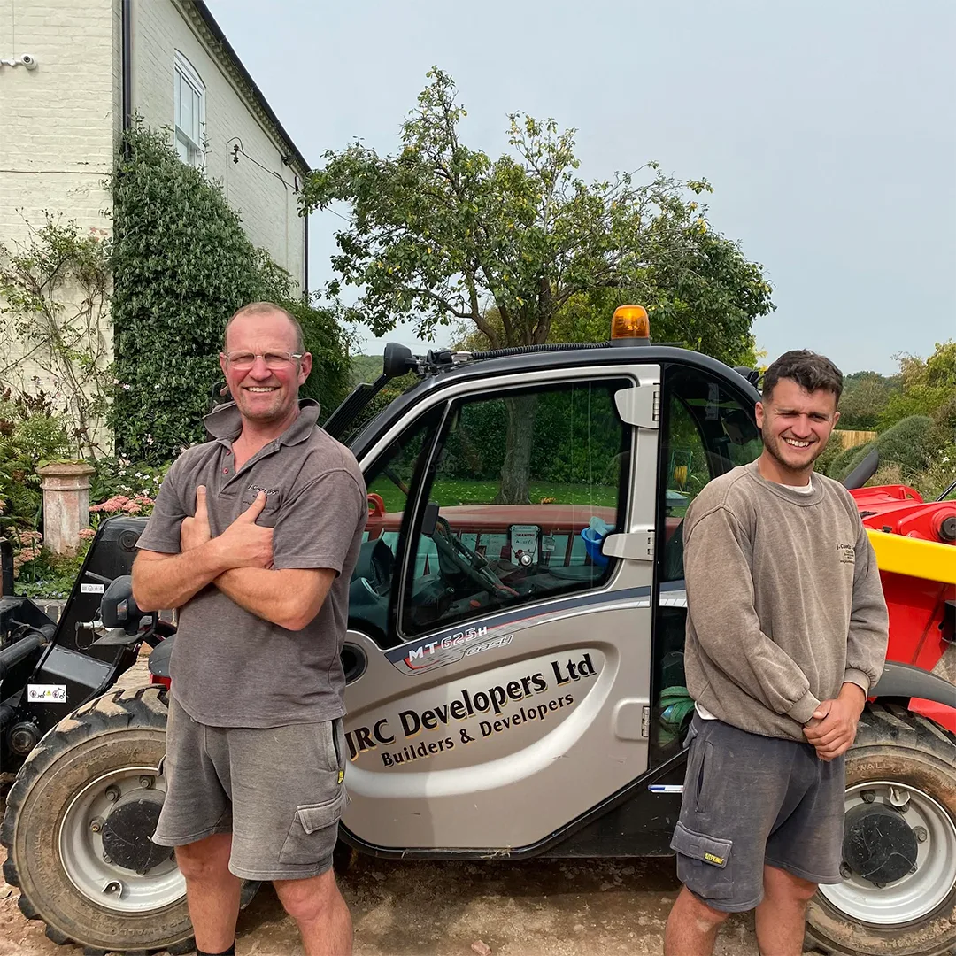 John and Jack in front of the JRC Developers telehandler
