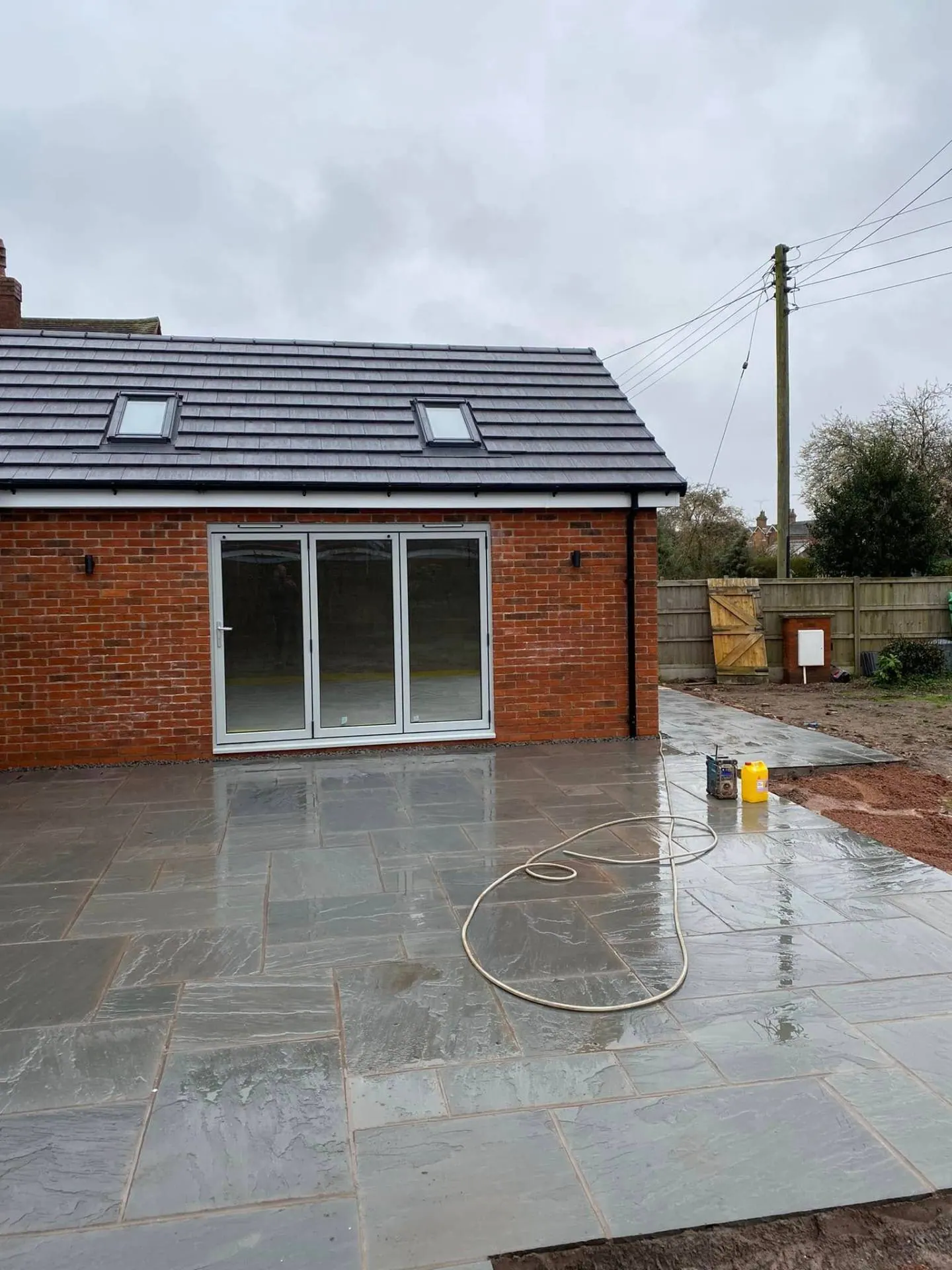 Rear elevation of White Gates showing new bifold doors and Indian sandstone patio