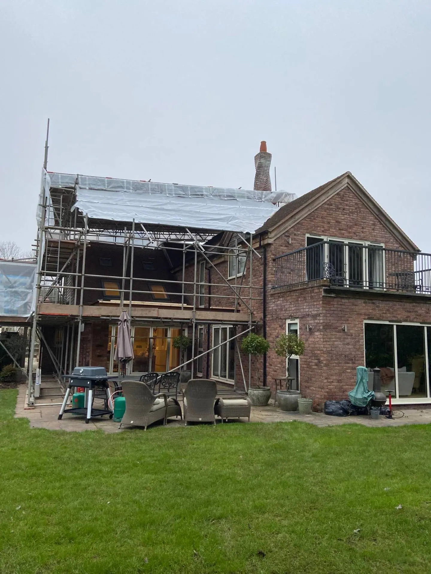 Rear elevation of Dingleside under full scaffold with shrink-wrap roof tent by JRC Developers