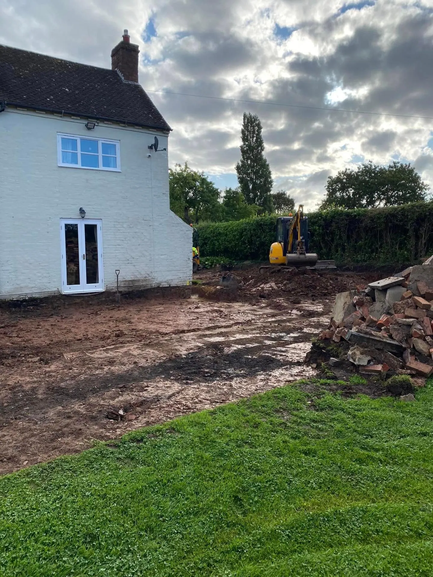 JCB excavator digging farmhouse extension foundations for JRC Developers