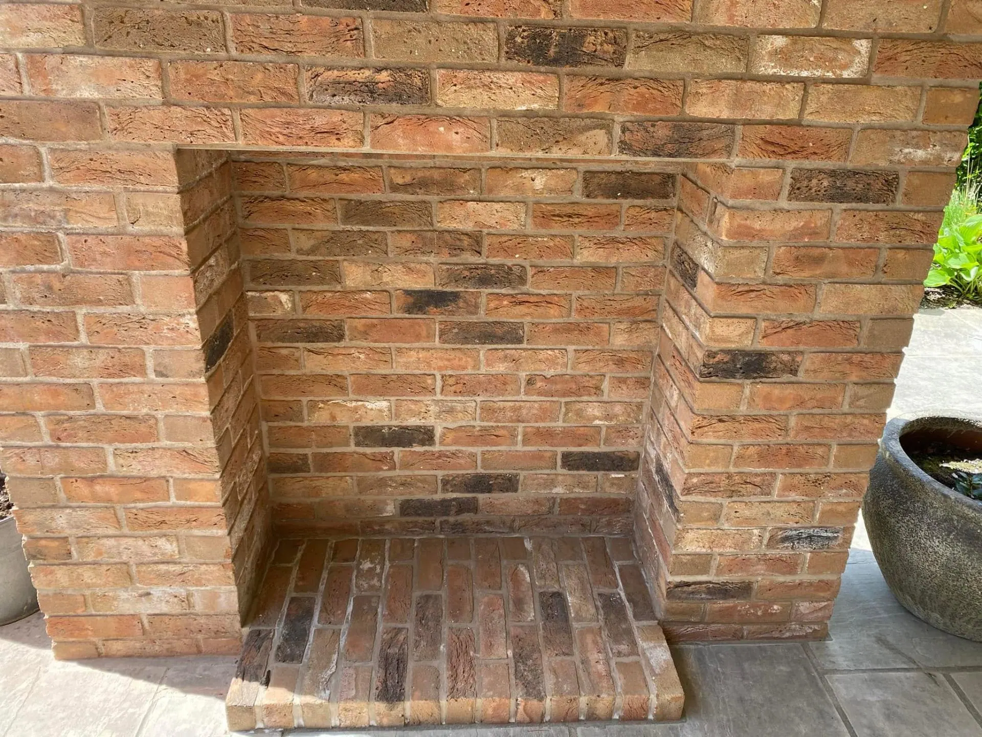 Reclaimed-brick outdoor fireplace niche at Dingleside — JRC Developers