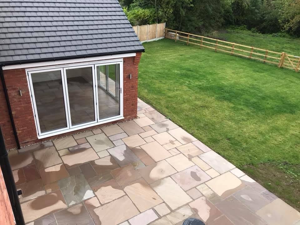 View of the sandstone patio, bifolds and lawn from an upstairs window at the Inkberrow new-build