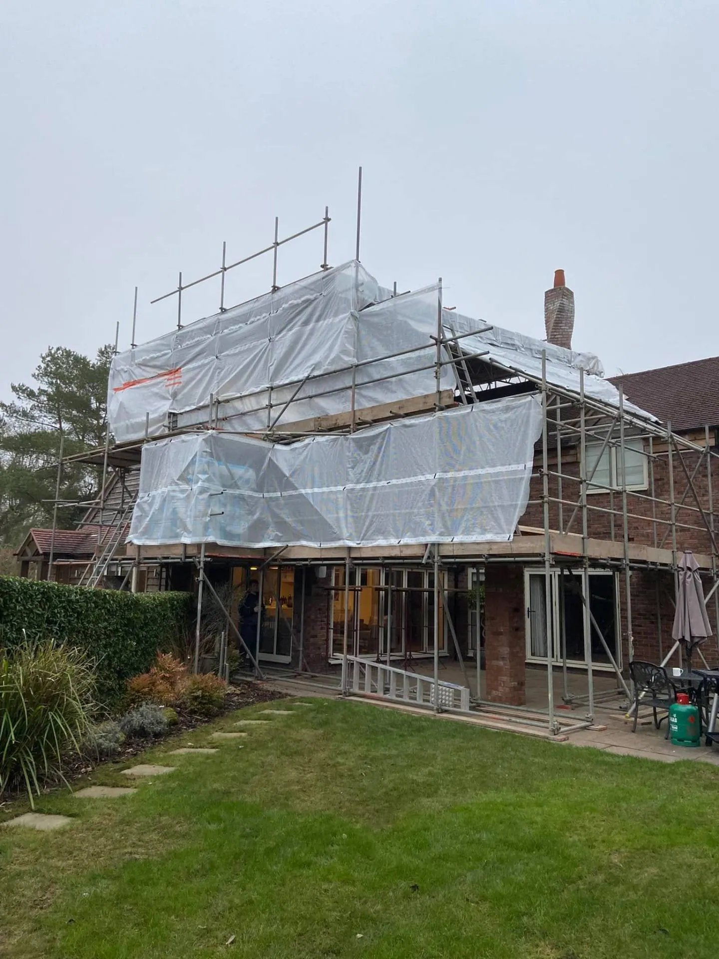 Full-height scaffold wrap over the covered terrace footprint at Dingleside — JRC Developers