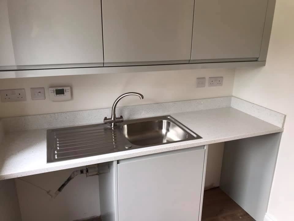 Utility room with stainless sink and quartz worktop at the Inkberrow new-build