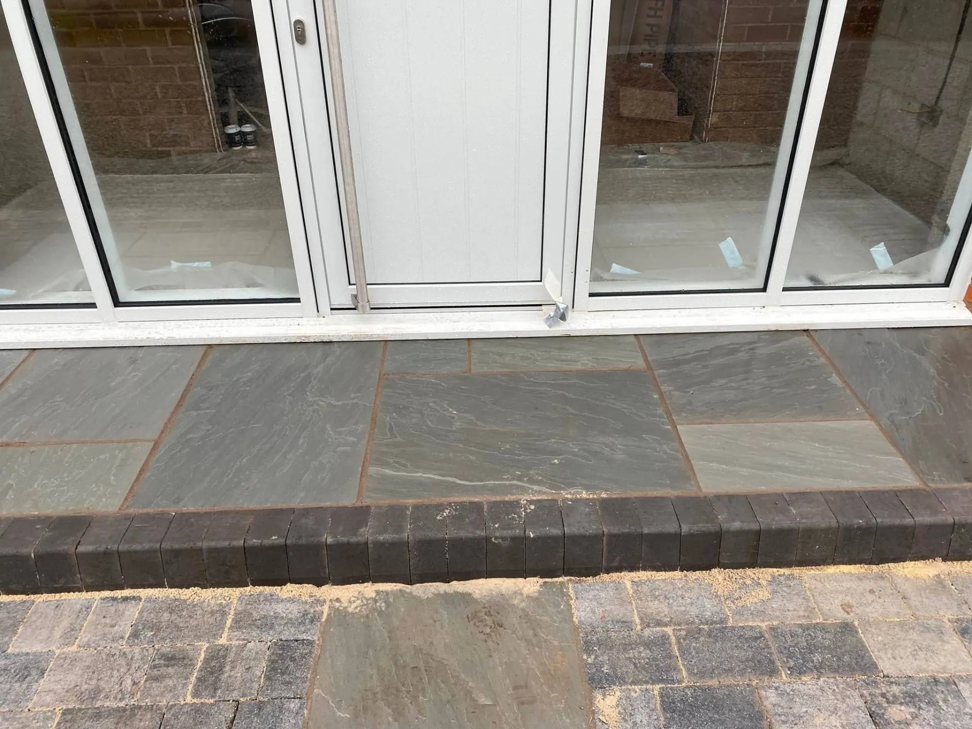 Indian sandstone step with charcoal soldier-course brick edging at White Gates
