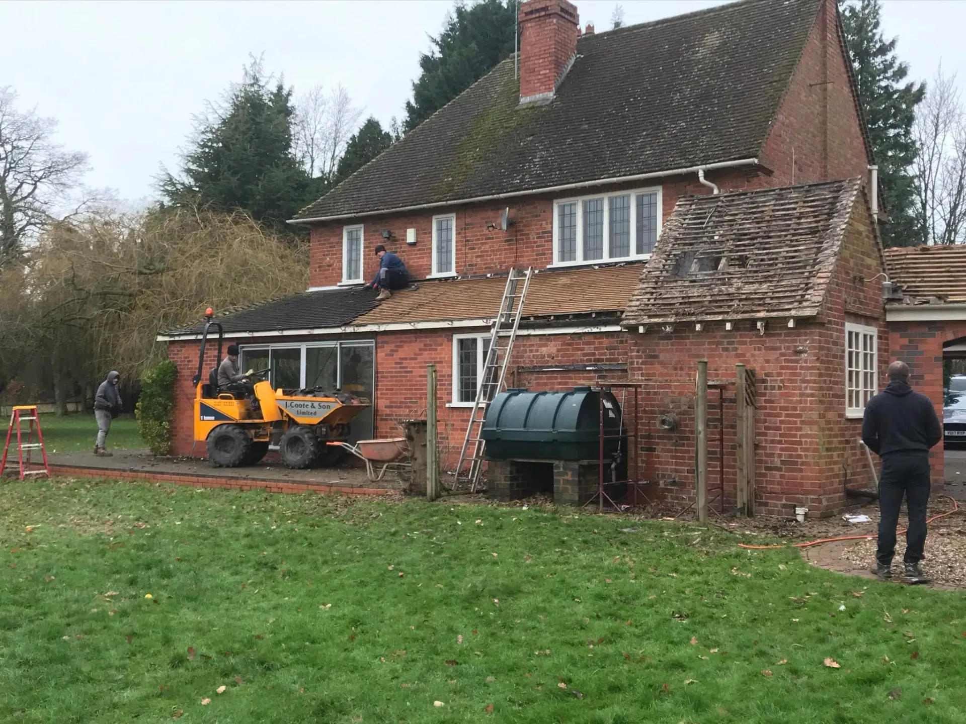 Rear and side view during the build showing roofing works to the altered house and garage range