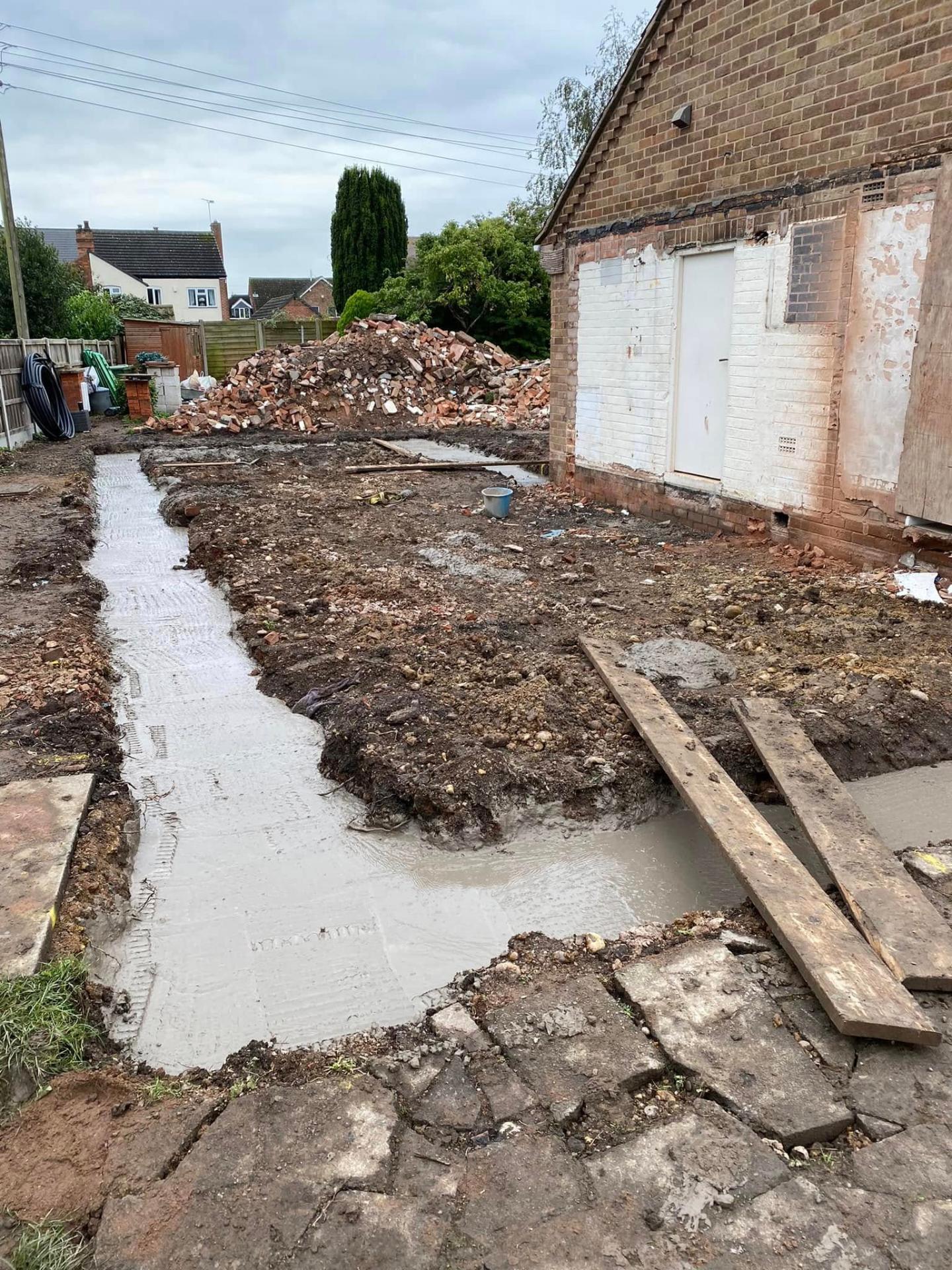 Freshly poured concrete strip foundations and drainage at White Gates