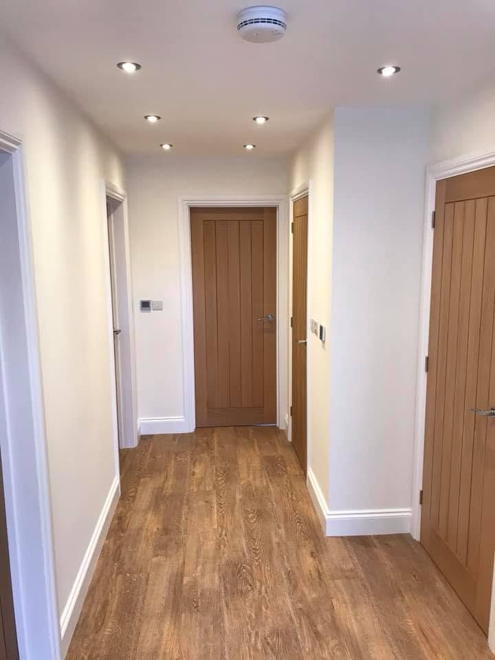 First-floor landing with oak doors and oak flooring at the Inkberrow new-build