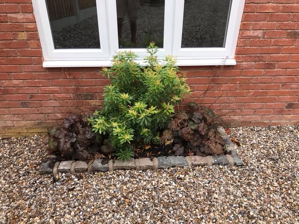 Landscaped planting bed against the Inkberrow new-build brickwork