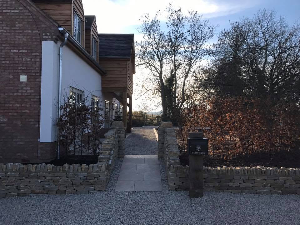Entrance to Willow House with dry stone walls, sandstone path, gravel drive and the house name post